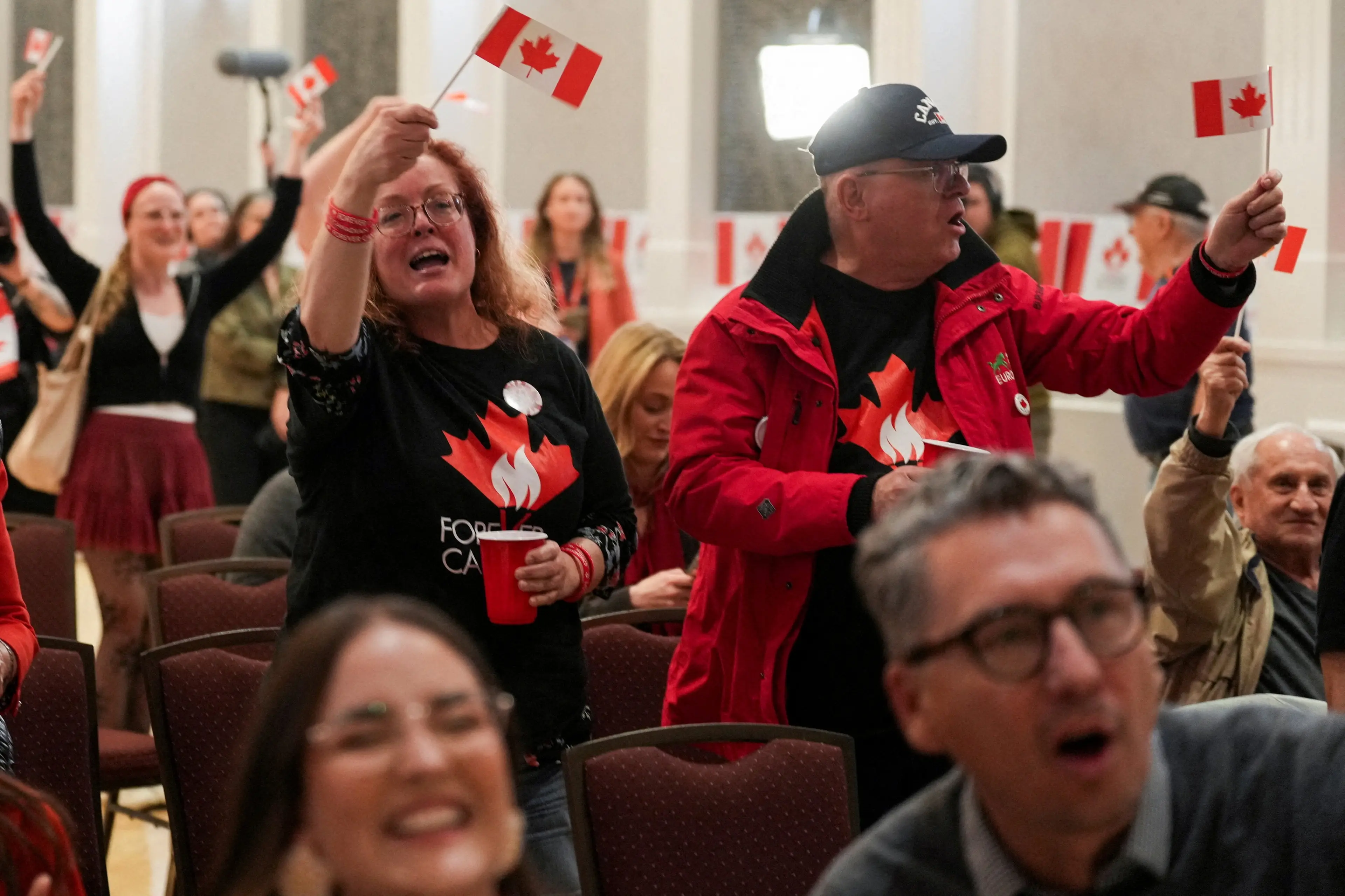 <p>Supporters of the Forever Canadian group, who want Alberta to remain in Canada, wave flags as they watch the results of the referendum on Alberta sovereignty in Edmonton. Photo: Reuters&nbsp;</p>\\n