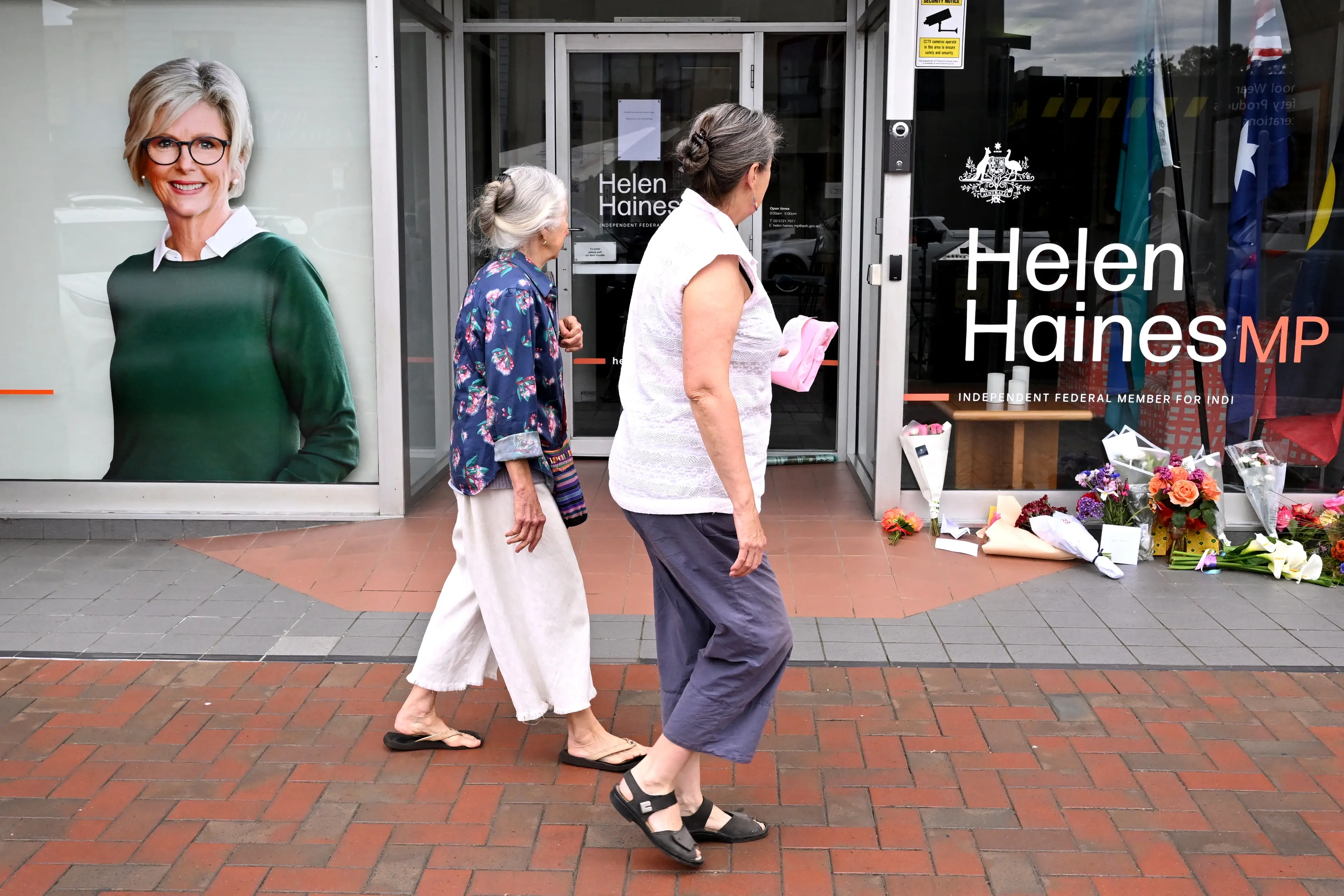 People lay flowers outside the Wangaratta office of Australian MP Helen Haines. Photo: Getty Images