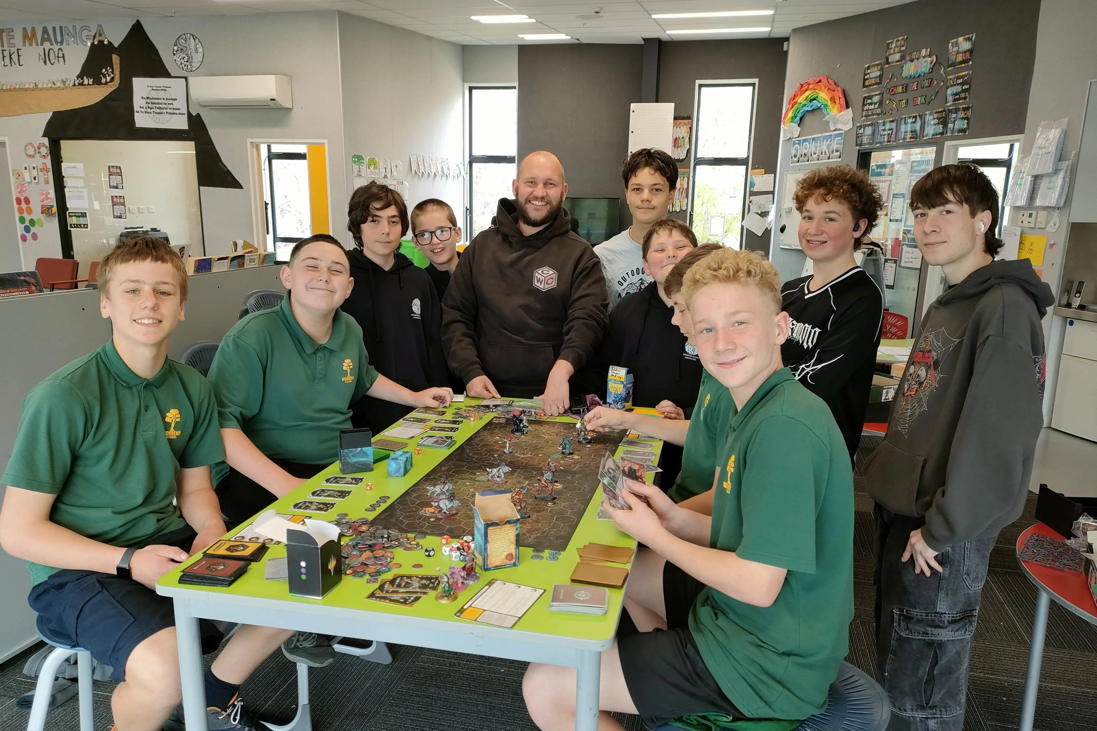 Matty Manzl (centre) chats to students at the Warhammer after school club at Woodend School. Photo: Supplied