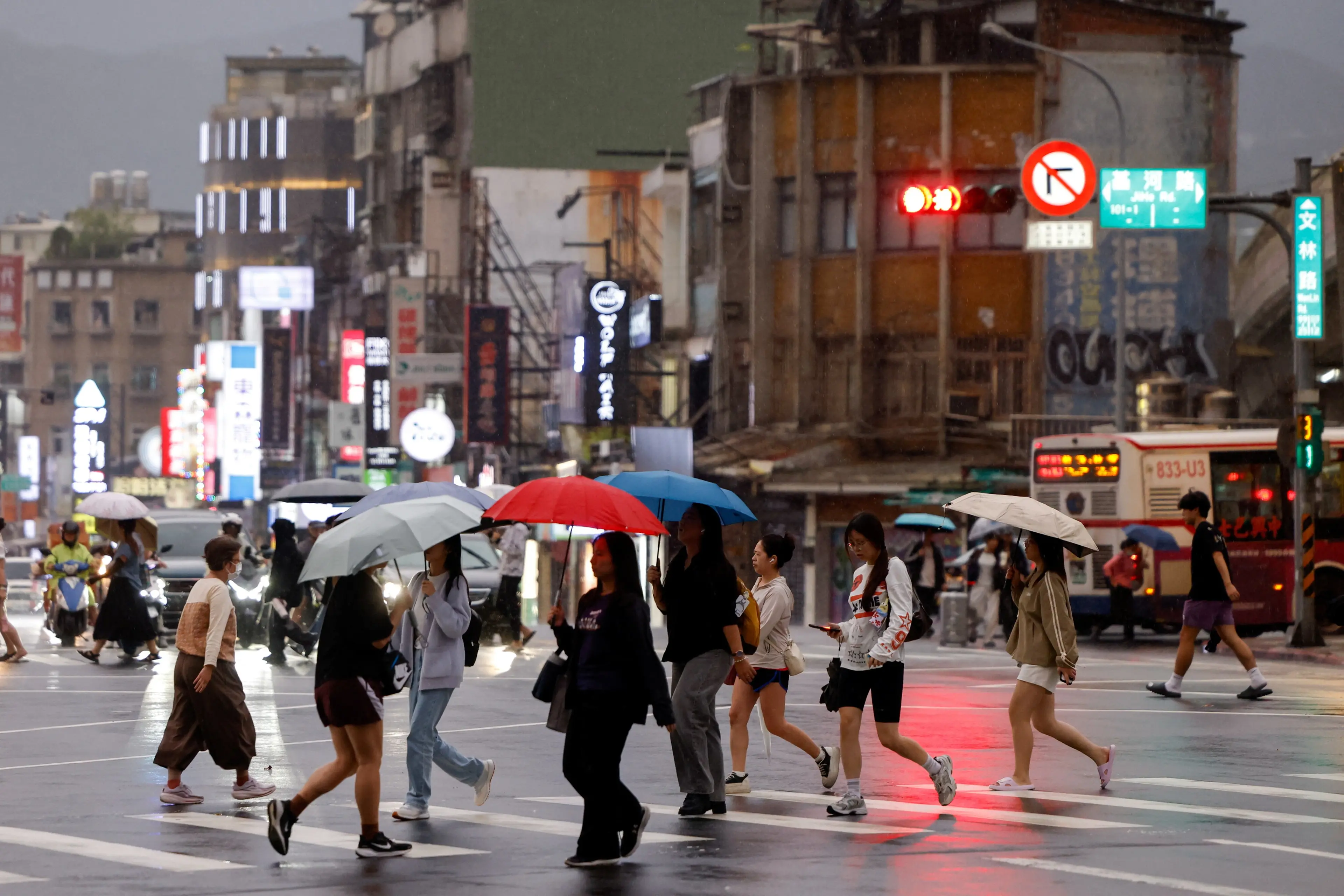 People walk through the rain in Taipei as Typhoon Champi approaches Taiwan. Photo: Reuters