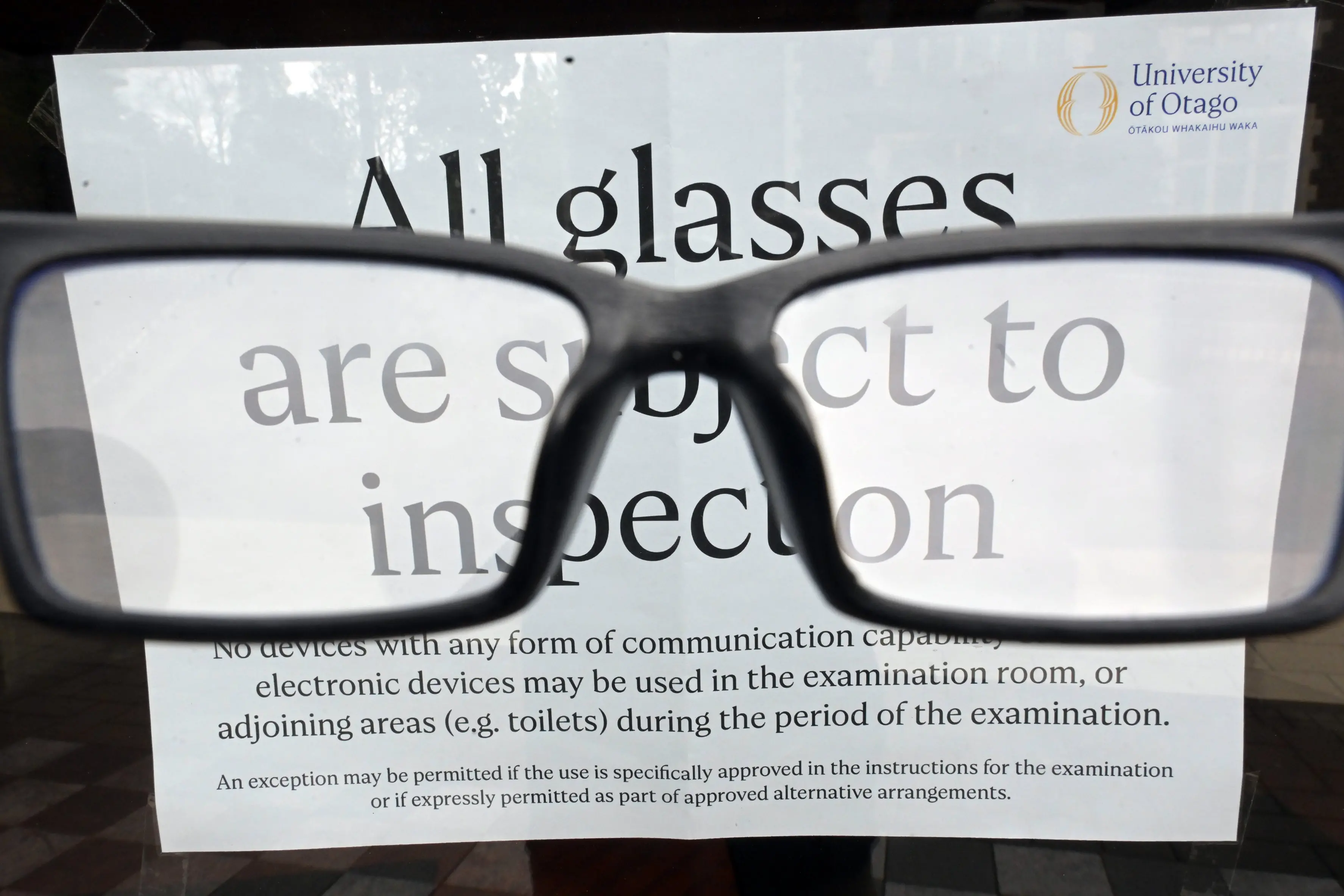 A notice saying \\' all glasses are subject to inspection \\' on the ouside of the University of Otago archway lecture theatres. Photo: Gerard O\\'Brien
