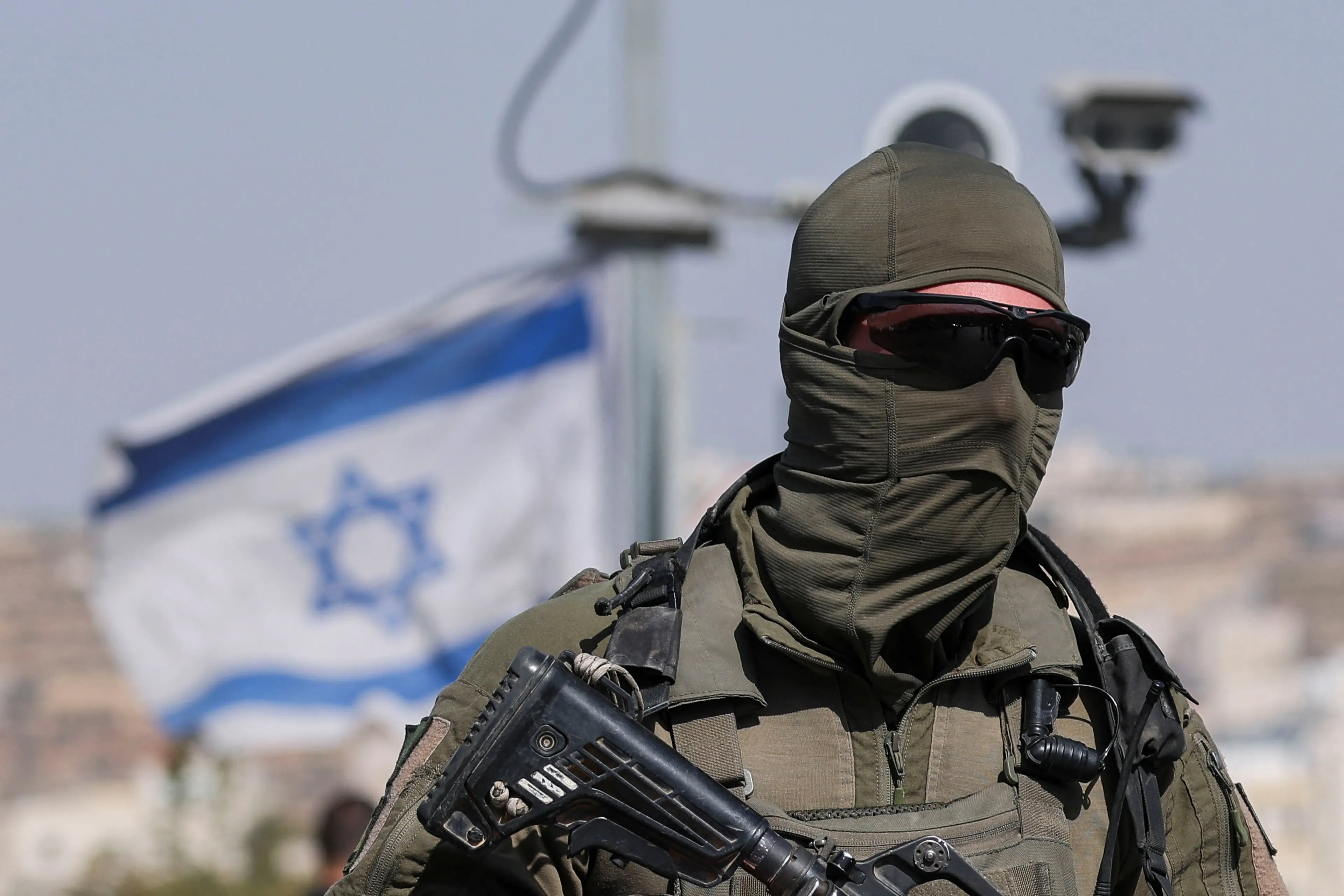 <p>A member of Israeli forces stands guard near a shooting scene in Hebron in the Israeli-occupied West Bank. Photo: Reuters </p>\\n
