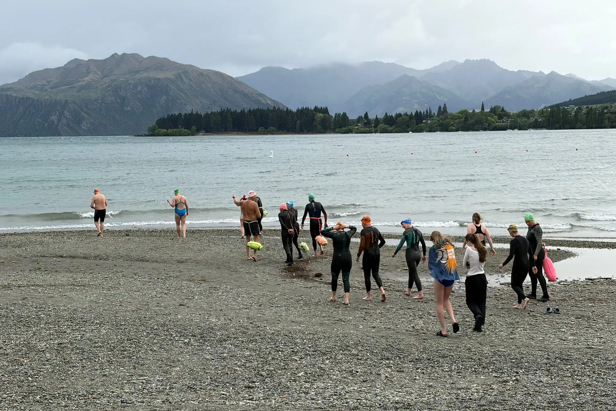 Wanaka Lake Swimmers make their way into the 12\\u00B0C water. Photo: Ruairi O\\'Shea