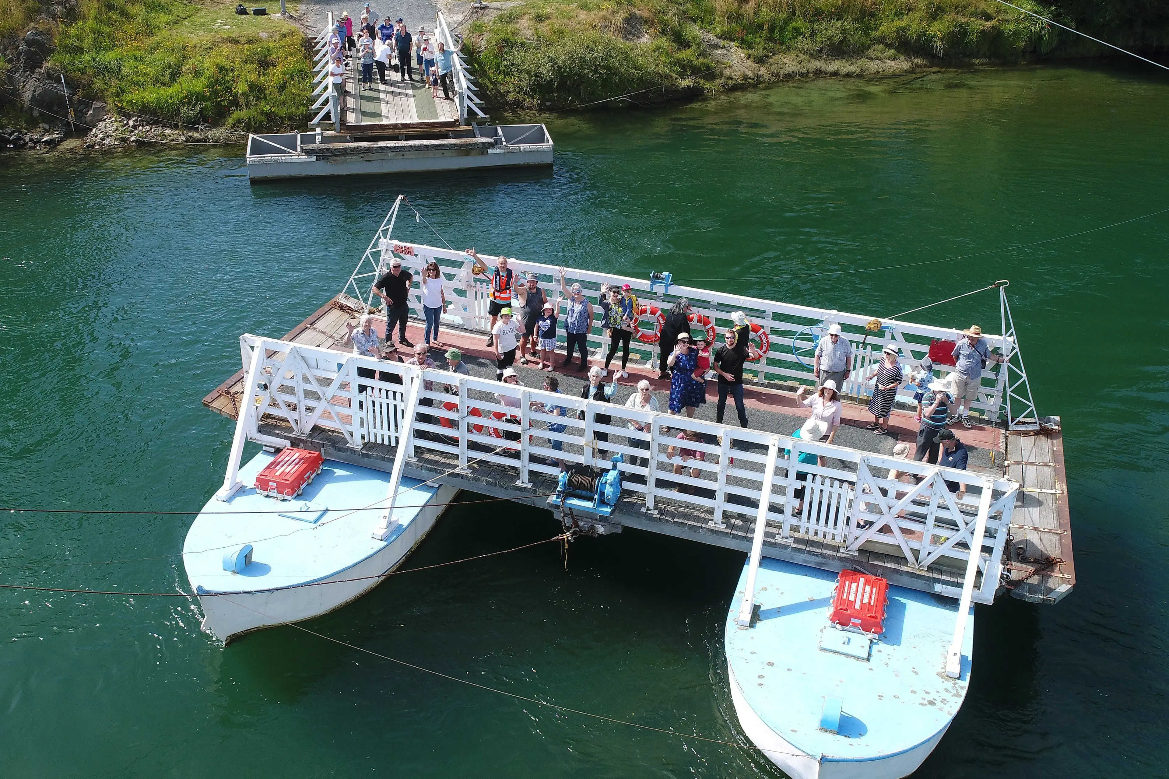 The Tuapeka Punt ferries passengers cross the Clutha River, at Tuapeka Mouth, during 125th anniversary celebrations in 2021. Photo: Stephen Jaquiery
